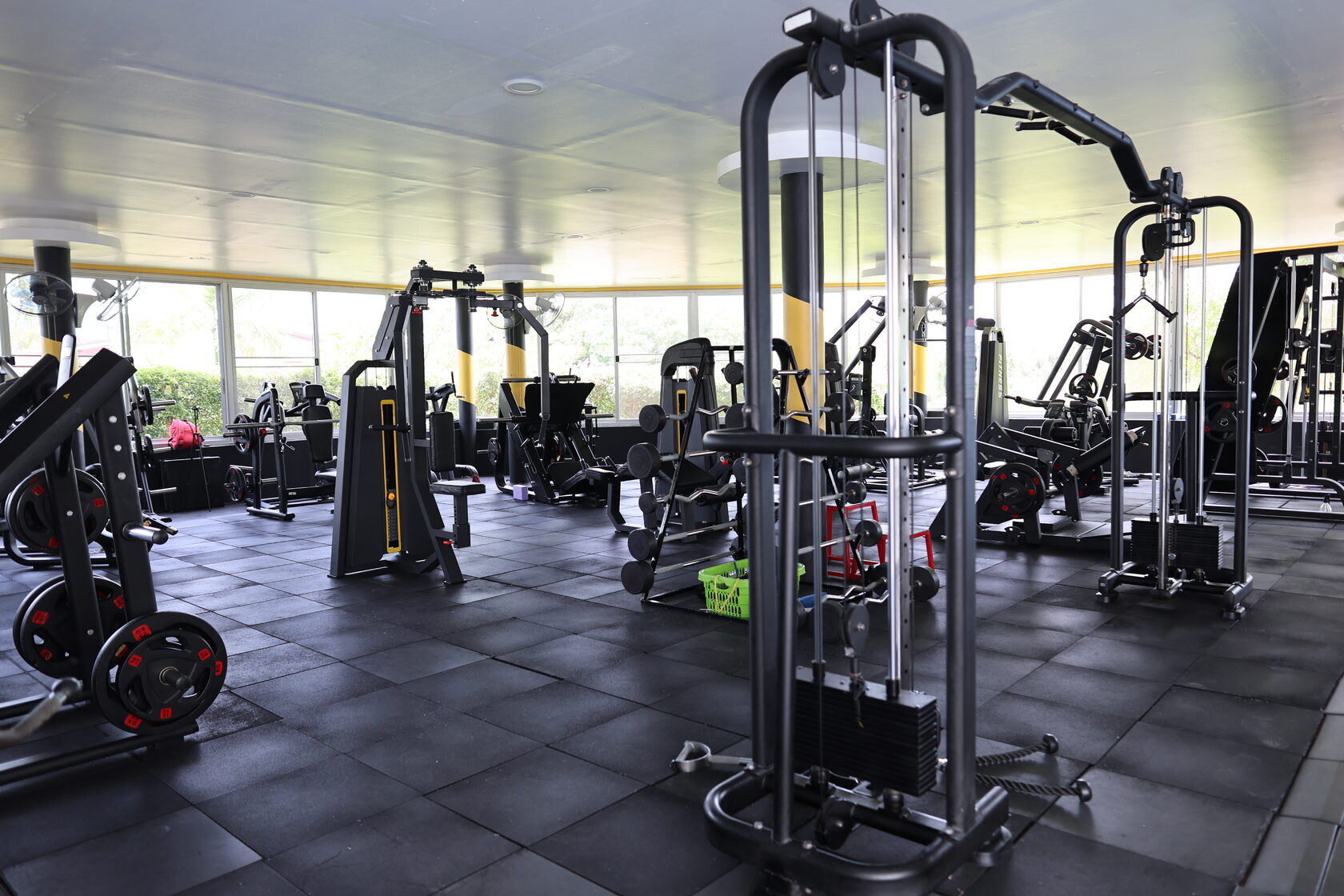 Modern gym at KAIF Jungle Club & Spa with large windows